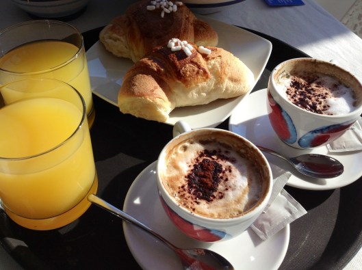 A classic Italian breakfast: cappuccino, orange juice and cornettis, the pastries can plain or filled with nutella, marmalade or chocolate. 
